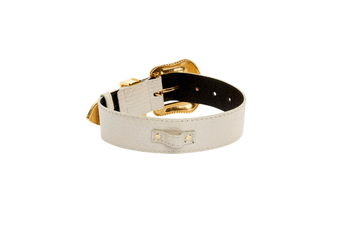 Off-white iridescent snake-patterned collar featuring a gold-tone buckle and Swarovski crystal details, shown partially coiled on a white background.