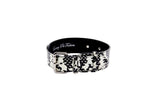 Black and white snake-patterned pet collar with silver buckle and hardware, shown against a white background.