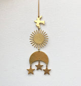 Brass hanging ornament with a bird at the top, a sunburst in the middle, and a crescent moon with three dangling stars at the bottom against a white background.