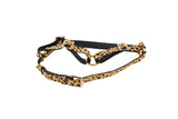 Adjustable black and leopard print leather harness with gold-tone metal buckles and central O-ring, displayed against a white background.