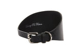 Black vegan leather dog collar 3 inches wide with silver metal buckle and D-ring, smooth texture and slight curve showing inner side with subtle white script text.