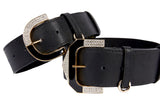 Two black leather collars with wide straps, featuring gold-tone buckles adorned with sparkling rhinestones, shown against a white background.