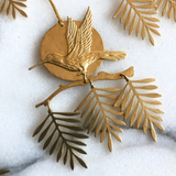 Sol Rising Mini Hanging/Ornament, hand-cut hammered brass wall hanging with hanging cord, shown indoors