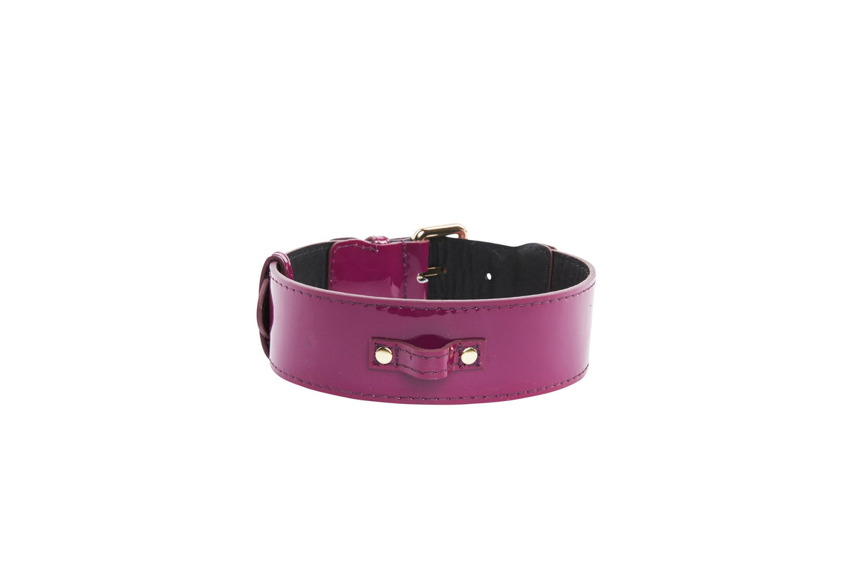 Glossy purple patent leather collar with classic silver buckle hardware and rivets, shown from the front on a white background.