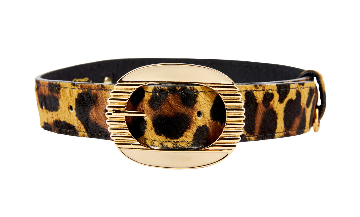 Leopard print hair-on-hide leather collar with an ornate oval gold-tone buckle featuring horizontal ridges on one side.