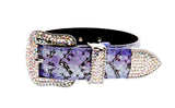 Purple and black iridescent snake-patterned belt with a large buckle and tip encrusted with clear Swarovski crystals, shown on a white background.