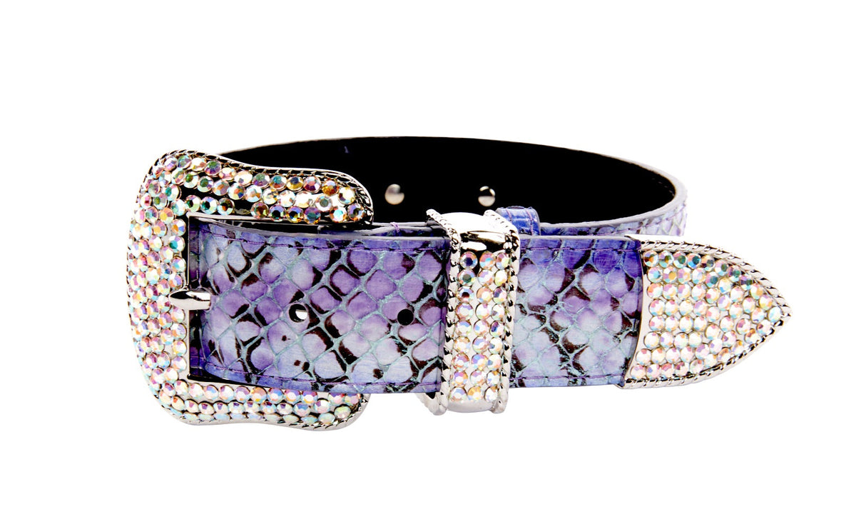 Purple and black iridescent snake-patterned belt with a large buckle and tip encrusted with clear Swarovski crystals, shown on a white background.