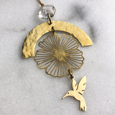 Hummingbird Prayer Ornament with brass frame and vintage glass crystal hanging indoors