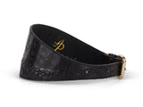 Black 3-inch wide collar with crocodile texture and gold-tone hardware, shown lying flat with a slight curve.