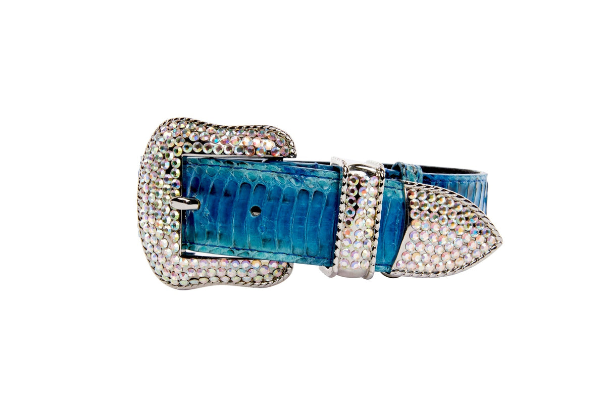 Blue snake-patterned leather belt with a large silver buckle encrusted with small crystals, featuring a matching silver crystal-encrusted belt loop and tip.