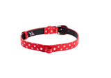 Red Italian leather collar with white polka dots and oval silver buckle hardware, shown coiled on a white background.