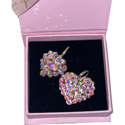 Two heart-shaped Swarovski crystal charms, one puffy and one flat, displayed together