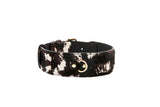 Collar featuring black, brown, and white hair-on-hide pattern with smooth black inner lining and classic gold D-ring and buckle hardware.