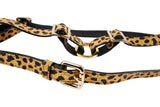 Leather harness with leopard print pattern featuring gold-tone metal rings and adjustable buckles, displayed on a white background.