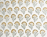 Close-up of a white fabric with a repeated pattern of stylized marigold flowers in mustard yellow and black outlines, arranged in evenly spaced rows.