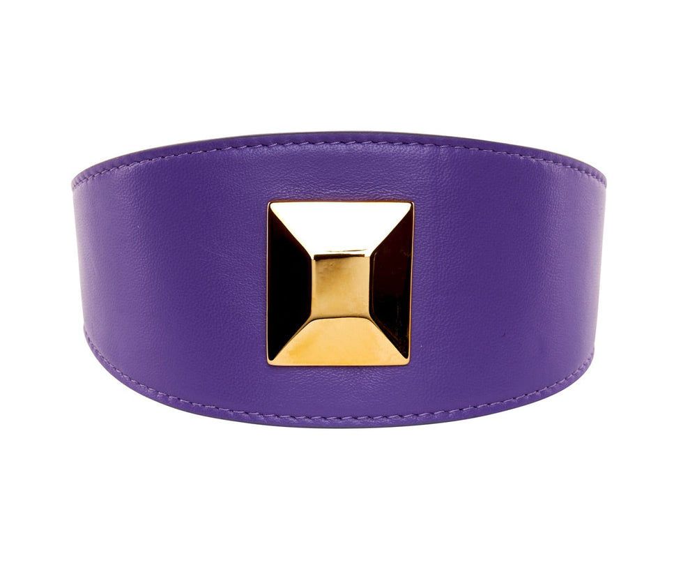 Wide purple leather collar with a large, square-shaped gold rivet centered on the front, featuring stitched edges for detail.