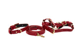 Red faux snake skin textured dog collar, leash, and adjustable harness set with gold-tone hardware, displayed side by side on white background.