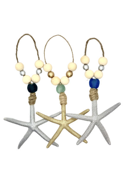 Set of three sea side holiday ornaments featuring gilded oyster shells or starfish with sea glass and beads