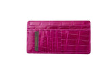Slim fuchsia card wallet with embossed crocodile pattern and a zip pocket on the back, shown flat on white background.