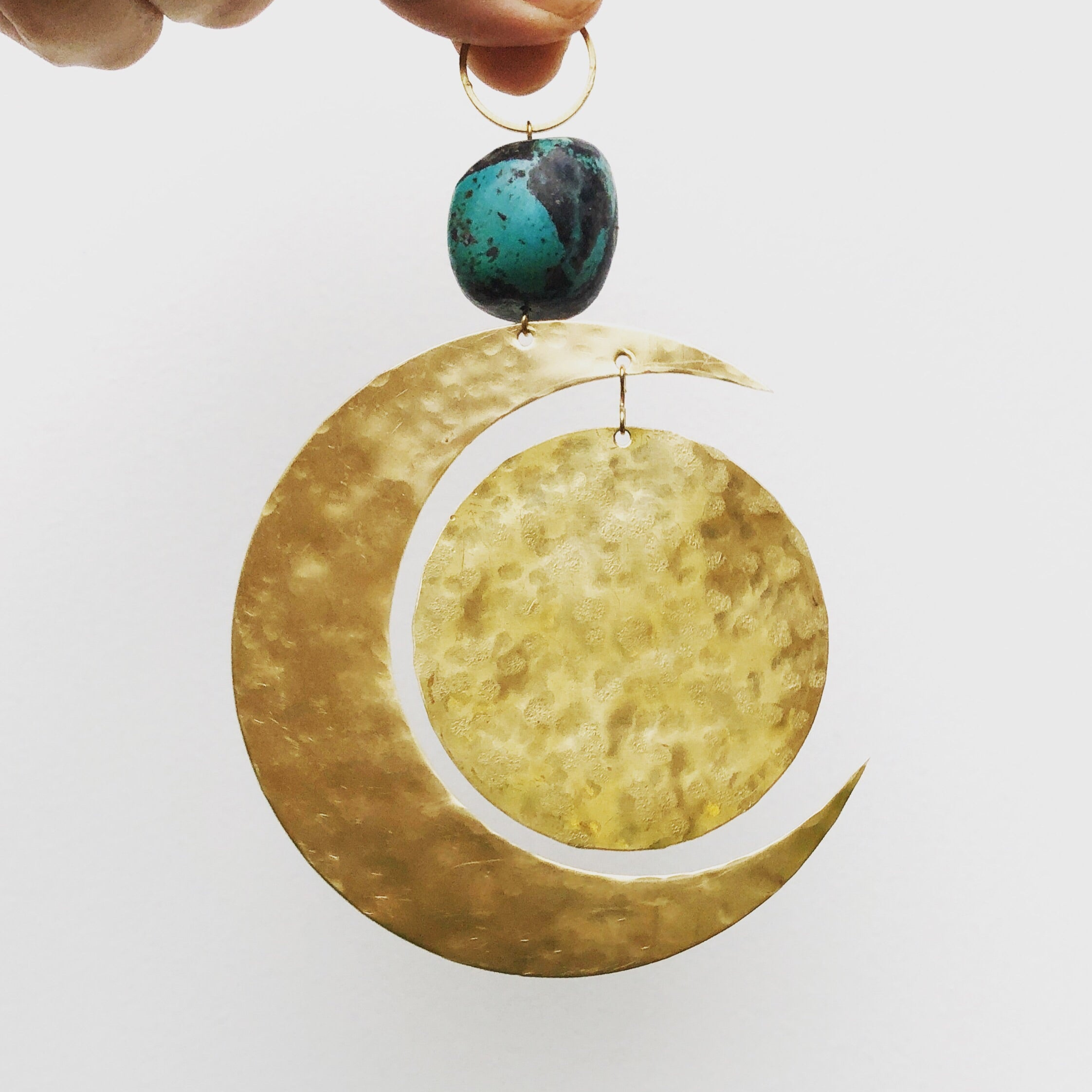 Blue Moon Mini Mobile wall hanging featuring brass and turquoise on a white wall
