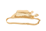 Gold Italian leather crossbody belt bag with floral embossing, oval shape, and tassel zip pull detail on a plain white background.