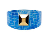 Blue patent embossed leather collar with a crocodile skin pattern and a large square gold pyramid stud centered on the band