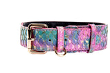 Colorful tilapia-patterned belt in pink, blue, and gold hues with gold classic buckle and D-ring, shown side view on white background.