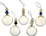 Five white scallop shells with gold-painted edges, each topped with a twine loop, a gold bead, and a differently colored round bead in blue, amber, green, light green, and cobalt blue.