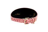 Wide pink collar with embossed belly side croc pattern and a gold-toned buckle and D-ring, shown flat against a white background.