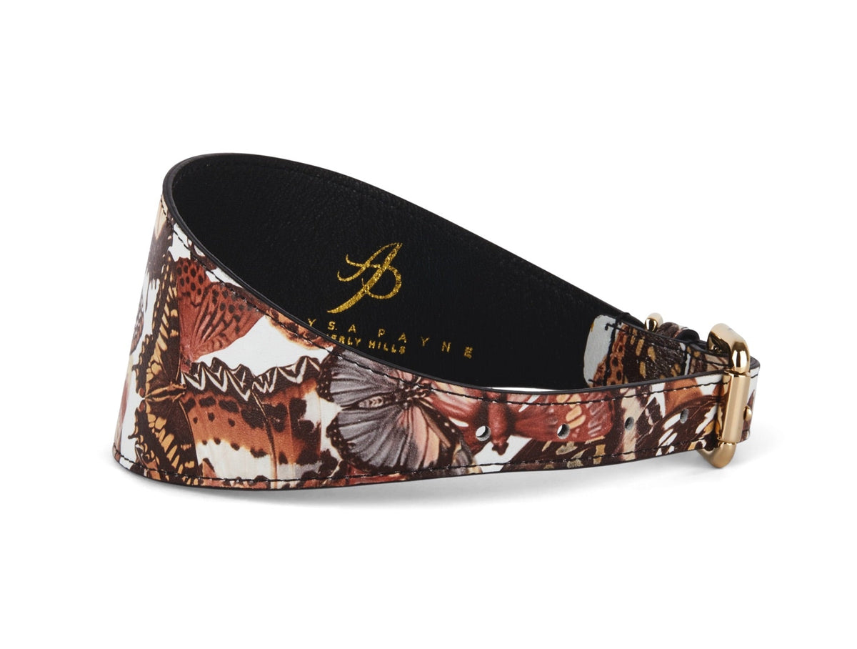3-inch wide black leather collar with a detailed butterfly print in shades of brown, white, and orange, featuring gold-tone buckle hardware.