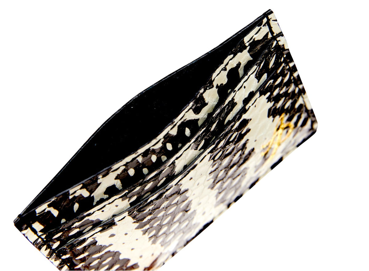 Slim card wallet with black and white snake scale pattern and a visible interior pocket, shown at a slight angle against a white background.