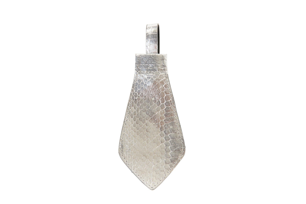 Silver tie pendant shaped like a viper snake scale with textured, hammered metal surface and a rectangular bail at the top for attachment.
