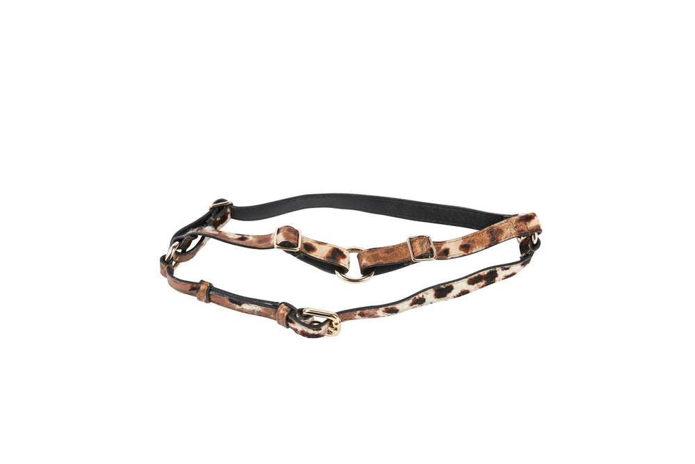 Black and leopard print Italian leather harness with bronze metal buckles and adjustable straps laid flat on white background.