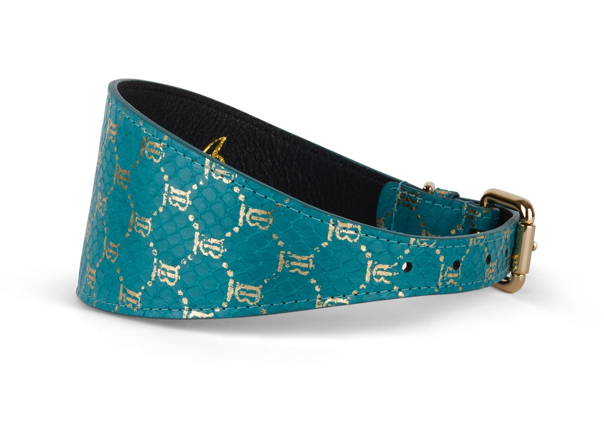 Teal leather dog collar 3 inches wide featuring a gold monogram snake pattern and a gold-tone buckle, shown in a side profile view.