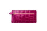 Rectangular fuchsia croc-embossed leather card wallet with a gold zipper pocket and matching pull tab on the front side.