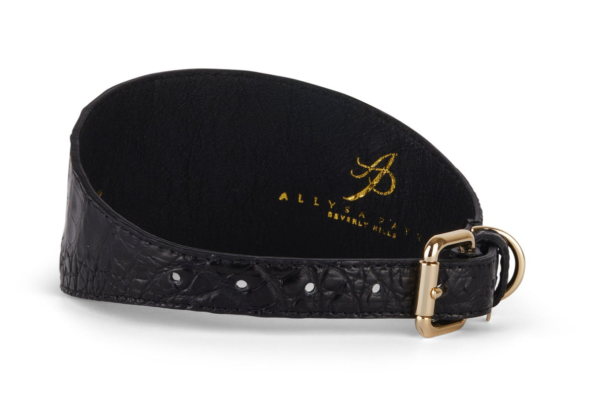 Black 3-inch wide textured crocodile-pattern collar with gold-tone buckle and stitched edges, shown curved with brand name imprint inside.