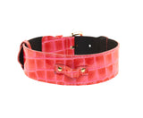 Wide classic collar in patent leather with an orange and pink crocodile texture, featuring a small strap with gold-tone hardware on a black inner lining.