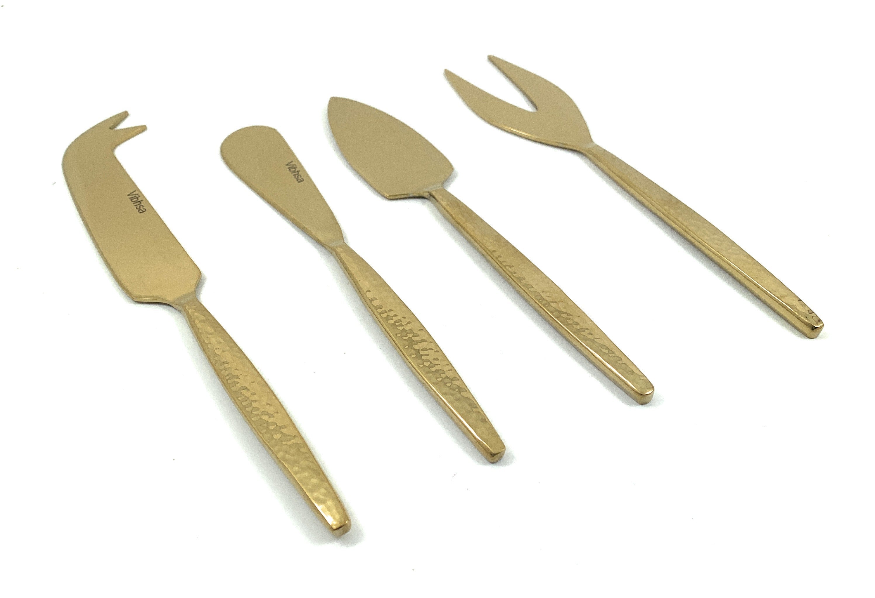 Golden Cheese knives set of 4 with hammered stainless steel handles arranged on a light surface