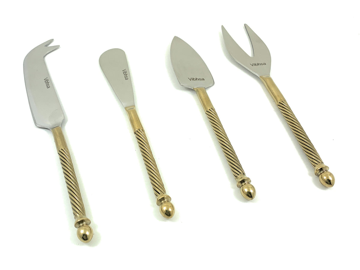 Set of four cheese knives with stainless steel blades and golden handles featuring a twisted design and rounded ends, arranged on a white background.
