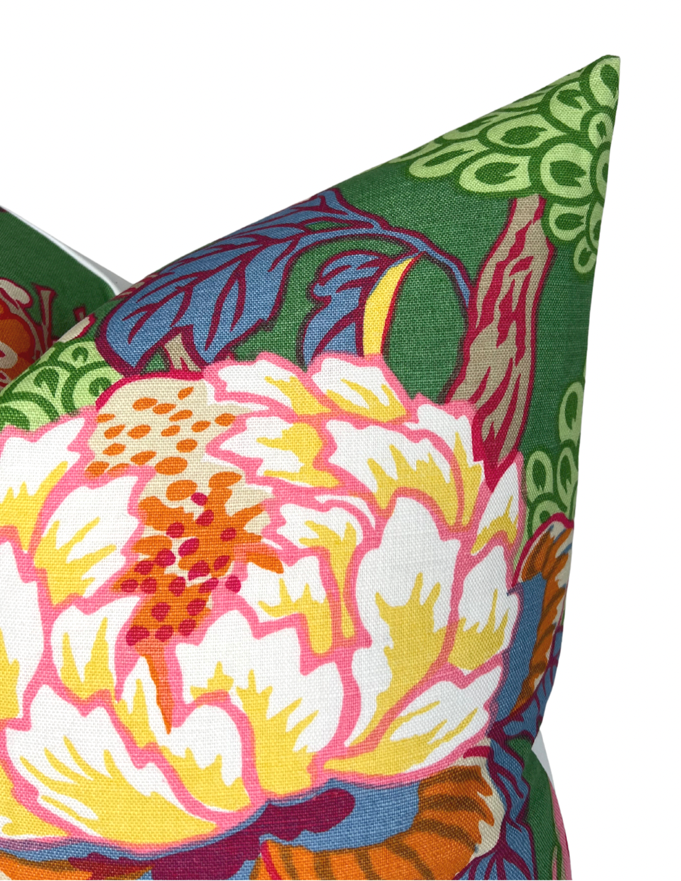 Corner of a green pillow cover featuring a bold floral pattern with large pink, yellow, and red blossoms and detailed dark blue and brown leaves.