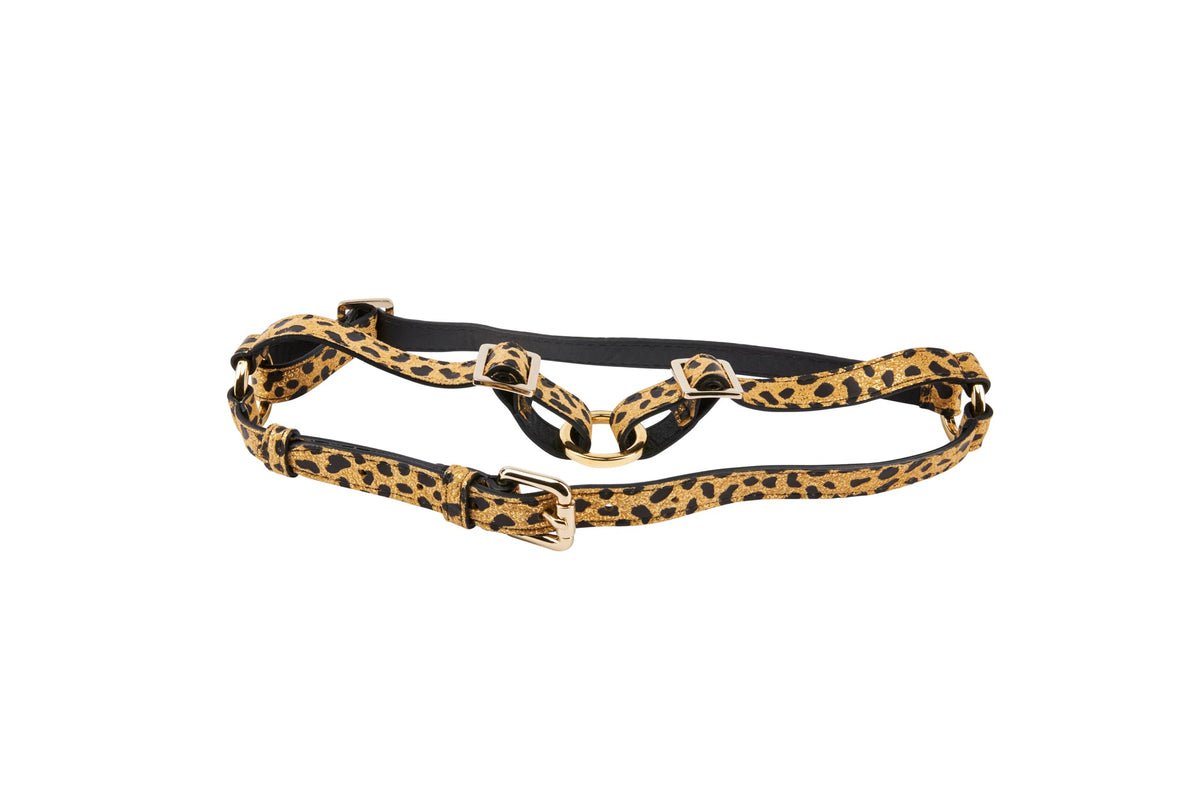 Adjustable harness with leopard print Italian leather straps and gold-tone metal buckles on a white background.