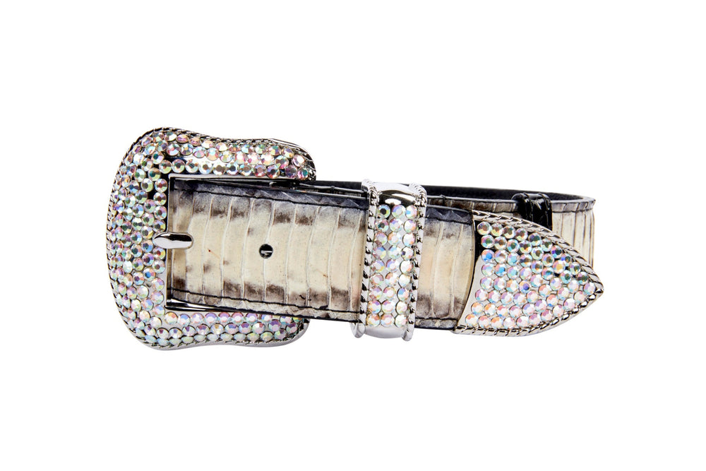 Close-up of an off-white and grey snake-patterned belt featuring a large silver buckle adorned with sparkling Swarovski crystals.