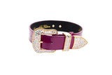Purple patent leather collar featuring a large gold buckle and tip encrusted with clear Swarovski crystals against a white background.
