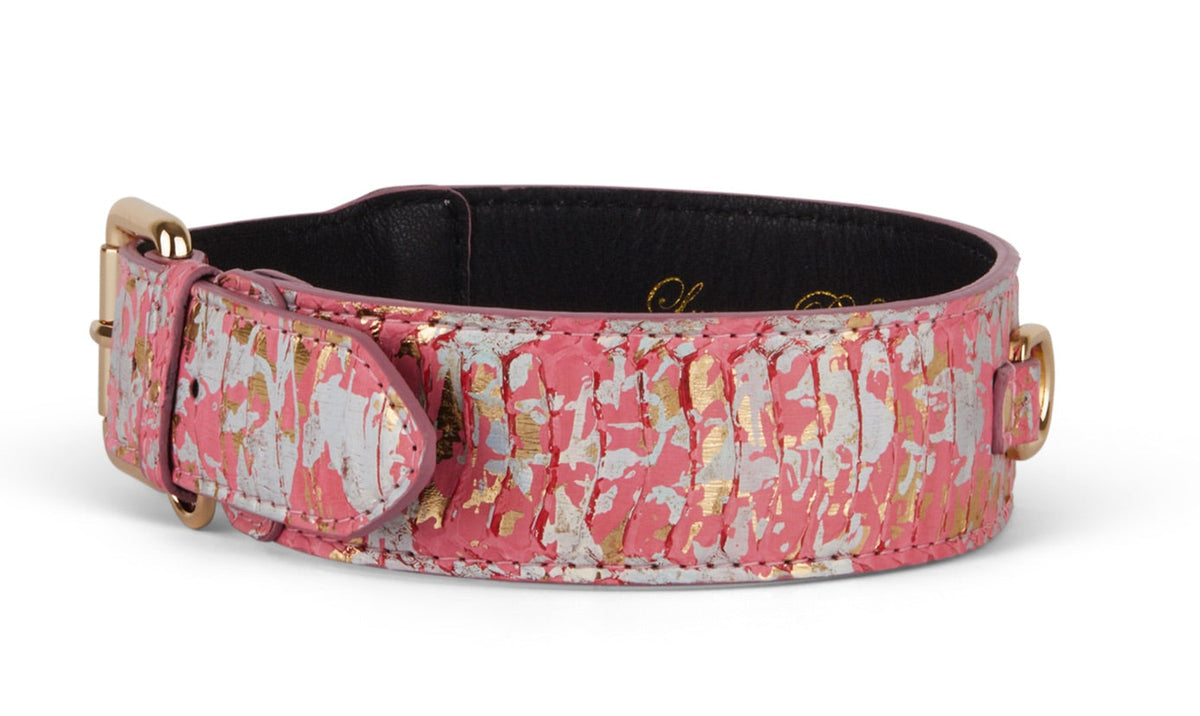Dog collar with iridescent pink, gold, and silver snake skin pattern, featuring a gold buckle and black interior lining.