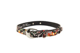 Black Italian leather dog collar featuring floral, skull, and snake print with a silver oval buckle and small D-ring detail.