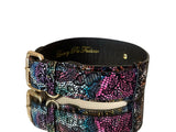 Black Italian leather dog collar with multicolor floral lace pattern and gold-tone classic buckle hardware, curved and displayed against a white background.