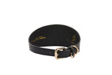 Black 2-inch wide vegan leather collar with gold buckle and D-ring, featuring embossed gold text on inner band
