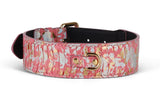 Wide dog collar with iridescent pink, gold, and silver abstract pattern featuring a gold metal D-ring and buckle on a black inner lining.