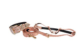 Copper embossed croc Italian leather collar, leash, and harness set with Swarovski crystal accents laid on a textured surface