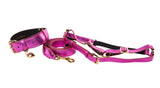 Reversible pink foil Italian leather dog collar with gold heart charm, paired with matching adjustable leash and harness set featuring gold hardware.